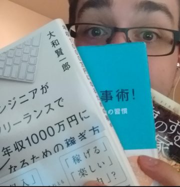 Matt holding 3 japanese books